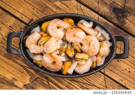 Ready for cooking fresh Raw Seafood Cocktail with Mussels, Clams, Prawns, Shrimps and squid in skillet. wooden background. top view Ready for cooking fresh Raw Seafood Cocktail with Mussels, Clams, Prawns, Shrimps and squid in skillet. wooden background. top view 126393642