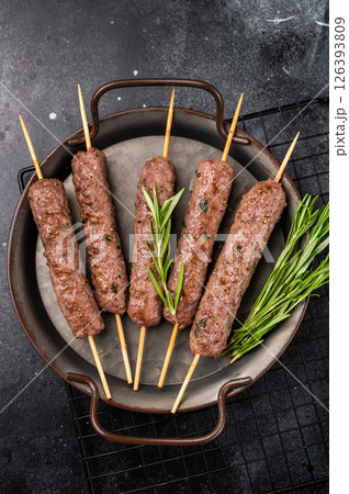 Grilled minced beef and lamb kebabs skewers with fresh spices, arabic kofta kofte kebab. black background. top view 126393809