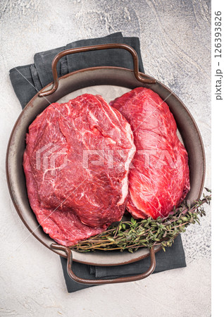 Uncooked beef cheeks, raw meat in steel tray. grey background. top view 126393826