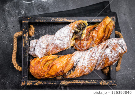 Roll pastry with Pistachios and chocolate, Danish Puff pastry. black background. top view Roll pastry with Pistachios and chocolate, Danish Puff pastry. black background. top view 126393840