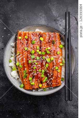 Unagi don, Unagidon Japanese grilled eel with rice in a bowl. black background. top view Unagi don, Unagidon Japanese grilled eel with rice in a bowl. black background. top view 126393864
