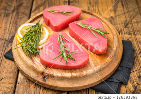 High quality raw tuna steak loin, perfect for a refreshing poke bowl or a delicious seared dish that impresses every time. wooden background. top view 126393868