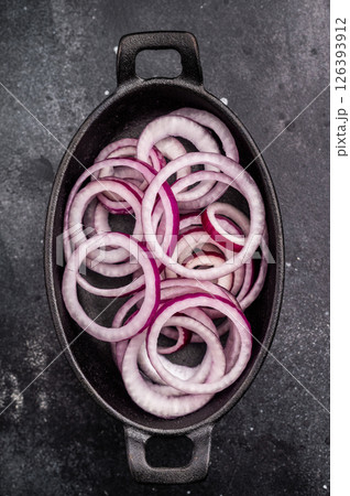 Fresh Raw onion rings in skillet. black background. top view Fresh Raw onion rings in skillet. black background. top view 126393912