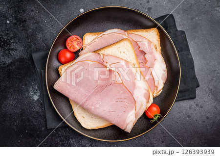 Ham sandwich, toast with sliced Prosciutto Cotto. black background. top view Ham sandwich, toast with sliced Prosciutto Cotto. black background. top view 126393939