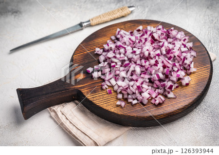 Chopped raw Red onion on wooden board. white background. top view 126393944