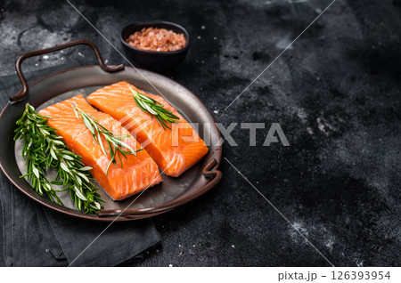 Raw Salmon fillet steak with rosemary ready for cooking. black background. top view Raw Salmon fillet steak with rosemary ready for cooking. black background. top view 126393954