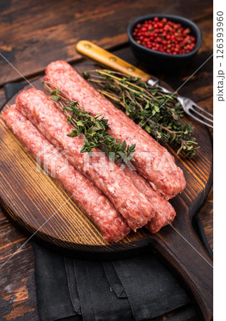 Balkan raw Cevapcici Sausage, fresh Cevapi from mince beef and pork meat. wooden background. top view Balkan raw Cevapcici Sausage, fresh Cevapi from mince beef and pork meat. wooden background. top view 126393960