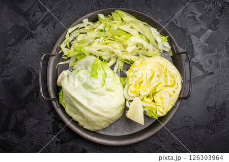 Fresh raw iceberg lettuce salad cut leaves. black background. top view 126393964