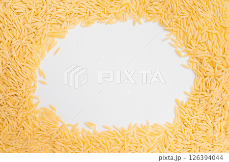 Pile of Uncooked Orzo pasta, raw dry Italian risoni isolated on white background. top view Pile of Uncooked Orzo pasta, raw dry Italian risoni isolated on white background. top view 126394044