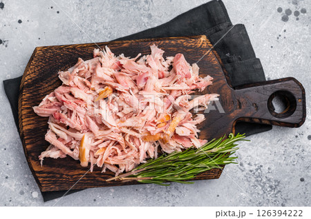 Shredded or Pulled Chicken meat on wooden board. grey background. top view Shredded or Pulled Chicken meat on wooden board. grey background. top view 126394222