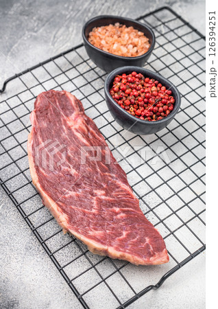 Fresh raw top sirloin steak, showcasing its rich color and marbling. grey background. top view 126394251