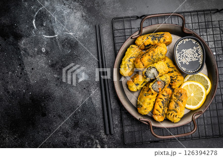 Crispy seaweed noodle rolls Gimmari, Korean deep fried seaweed rolls. black background. top view Crispy seaweed noodle rolls Gimmari, Korean deep fried seaweed rolls. black background. top view 126394278