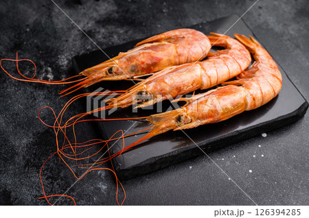 Fresh red Argentine shrimps, raw Prawns Langostino Austral. black background. top view Fresh red Argentine shrimps, raw Prawns Langostino Austral. black background. top view 126394285