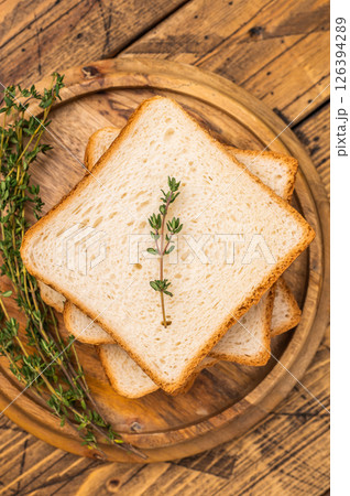 Ready for toasts Slices of wheat bread. wooden background. top view Ready for toasts Slices of wheat bread. wooden background. top view 126394289