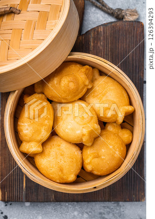 Japanese Taiyaki Fish Shaped Cake with Sweet Red Bean Paste. grey background. top view Japanese Taiyaki Fish Shaped Cake with Sweet Red Bean Paste. grey background. top view 126394293