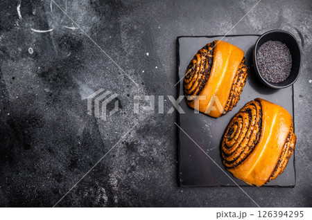 Sweet buns with poppy seed. black background. top view Sweet buns with poppy seed. black background. top view 126394295
