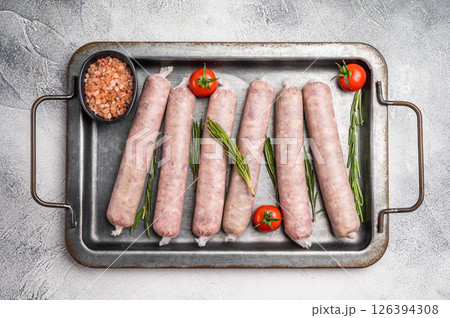 Fresh Sausages with minced pork and veal meat, wurst with herbs. grey background. top view 126394308