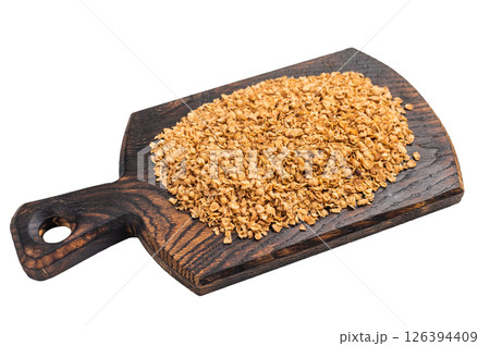 Buckwheat flakes on a wooden board isolated on white background. top view Buckwheat flakes on a wooden board isolated on white background. top view 126394409