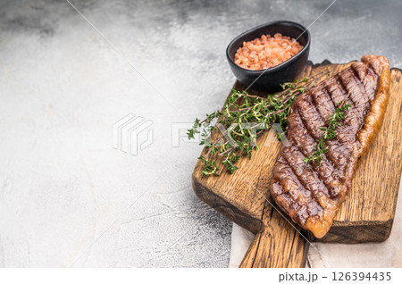 Grilled Top Sirloin, cooked rump beef steak. grey background. top view 126394435