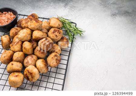 Fried Meatballs from beef and pork minced meat garnished with fresh herbs. grey background. top view Fried Meatballs from beef and pork minced meat garnished with fresh herbs. grey background. top view 126394499