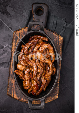 Korean Beef Meat Bulgogi Hot Plate. black background. top view 126394529