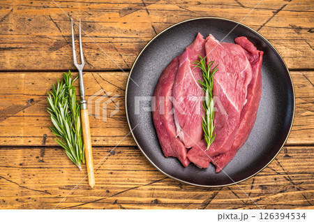 Raw Duck breast fillet slices for stir-fry cooking. wooden background. top view Raw Duck breast fillet slices for stir-fry cooking. wooden background. top view 126394534