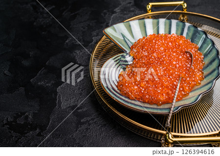 Bright red caviar, a gourmet delight that adds a burst of flavor to any dish or celebration. grey background. top view 126394616