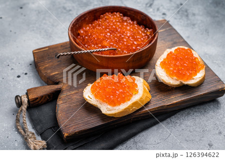 Salty salmon roe, red caviar, ideal for adding a touch of elegance to your culinary creations. grey ackground. top view Salty salmon roe, red caviar, ideal for adding a touch of elegance to your culinary creations. grey ackground. top view 126394622