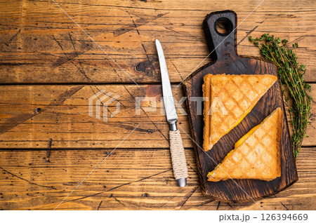 Toasted pressed cheese sandwich on wooden board. wooden background. top view 126394669