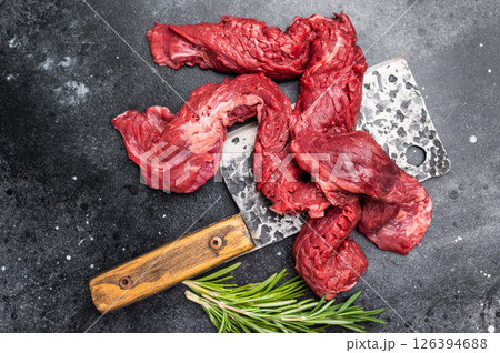 Alternative Beef cut Machete Skirt Steak, raw prime meat on butcher table. black background. top view Alternative Beef cut Machete Skirt Steak, raw prime meat on butcher table. black background. top view 126394688