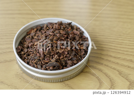 Pile of instant granulated cocoa nibs on a wooden table Pile of instant granulated cocoa nibs on a wooden table 126394912