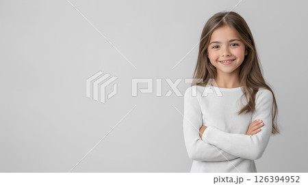 A professional studio portrait of a girl on a light plain background, expressing love and warmth with her arms wrapped around herself and a soft smile 126394952