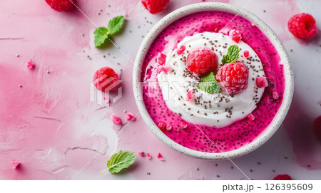 A bowl of layered chia pudding with raspberry puree, coconut yogurt, and fresh mint, minimalistic with a clean design, concept of healthy eating 126395609