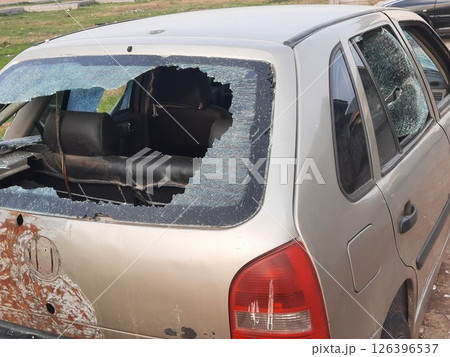 Breaking into a car parked on the street 126396537