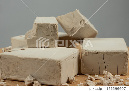 Fresh Compressed Yeast Blocks on Gray Background 126396607