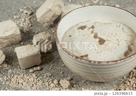 Activation of wet fresh yeast in warm water with sugar. 126396615