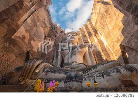 statue of ancient buddha in Sri Chum Temple in Sukhothai Historical Park, a UNESCO World Heritage Site.the famous landmark place for tourist sight seeing attraction in Sukhothai, northern Thailand statue of ancient buddha in Sri Chum Temple in Sukhothai Historical Park, a UNESCO World Heritage Site.the famous landmark place for tourist sight seeing attraction in Sukhothai, northern Thailand 126396788