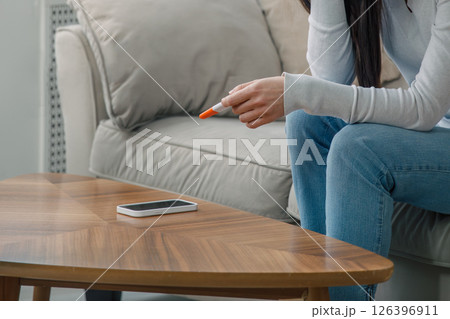 Anonymous Woman Holding a Pregnancy Test, Expressing Stress and Uncertainty 126396911