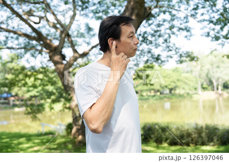 Wellness and Fitness. Senior man stretching in park for healthy lifestyle. 126397046