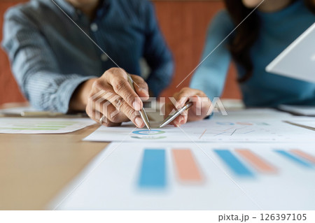 ESG Business Discussion. Professionals analyzing data and charts for sustainable development. ESG Business Discussion. Professionals analyzing data and charts for sustainable development. 126397105