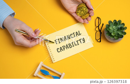Financial capability concept. Knowledge, skills, and confidence to manage money effectively and make informed financial decisions. Woman points to an inscription on a notepad 126397318