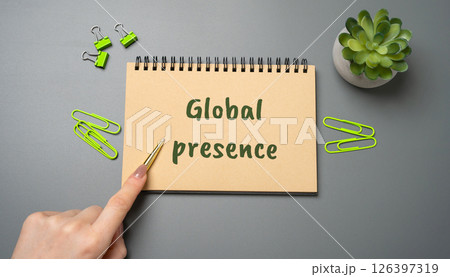 Global presence concept. Company's ability to operate, influence, or maintain a brand and services across multiple countries and international markets. A woman points to an inscription on a notepad 126397319
