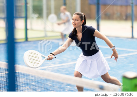 woman participates in a paddle tennis tournament 126397530