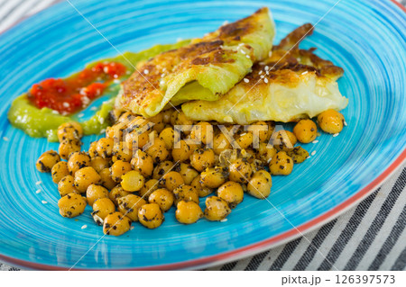 Image of cabbage leaves in batter with garbanzos and sauce 126397573