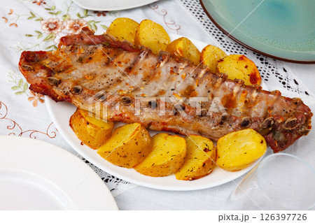 Roasted pork ribs with fried potatoes Roasted pork ribs with fried potatoes 126397726