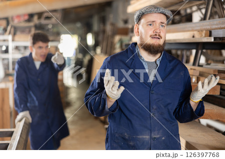 Owner of furniture factory yells at a guilty worker and throws him out of work Owner of furniture factory yells at a guilty worker and throws him out of work 126397768
