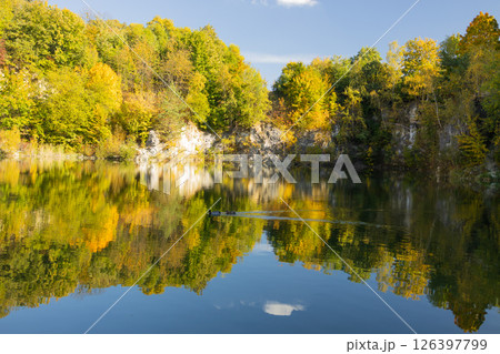 Autumn forest lake in Poland. Autumn lake in autumn forest. The autumn foliage of the trees is reflected in the lake water Autumn forest lake in Poland. Autumn lake in autumn forest. The autumn foliage of the trees is reflected in the lake water 126397799