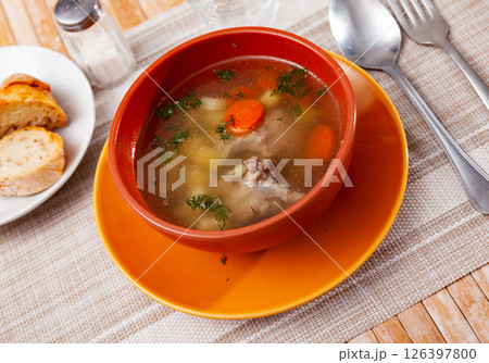 Bowl with meat soup served on table Bowl with meat soup served on table 126397800