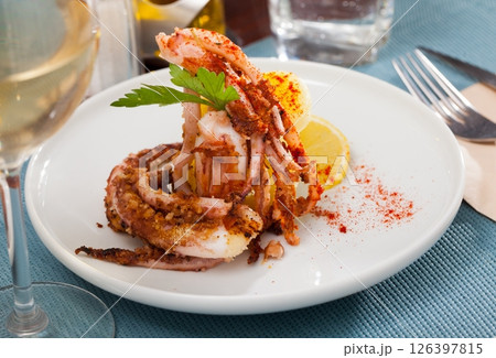 Fried tentacles squid with potatoes 126397815