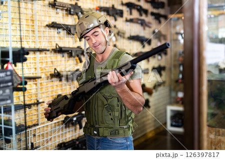 Man in army uniform with weapon in military market 126397817